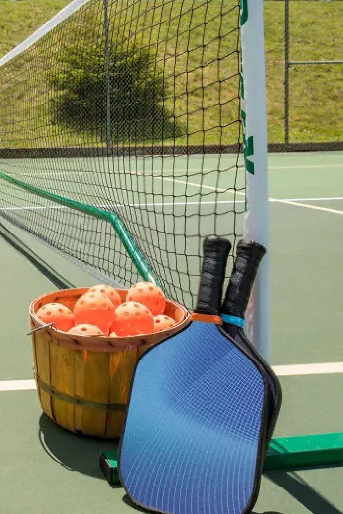 Pickleball equipment sitting next to the net Pickleball equipment sitting next to the net