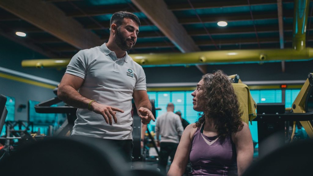 A man talking to a woman in a gym